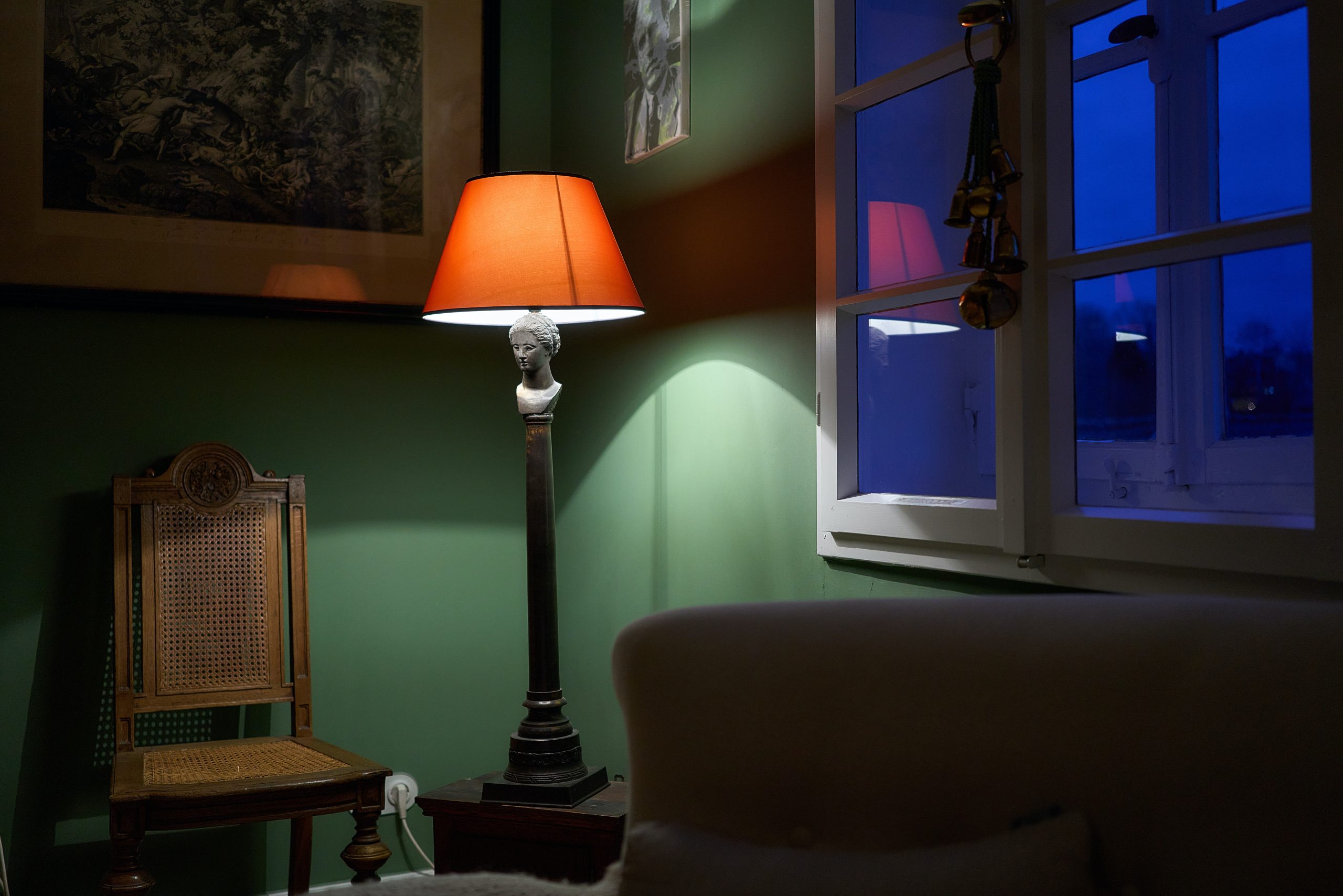 Espacio iluminado con una lámpara de piso con estilo clásico y pantalla anaranjada